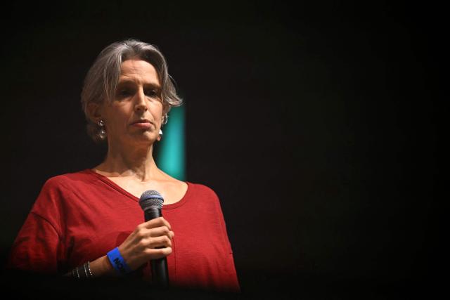 Swiss journalist and writer Mona Chollet looks on from the stage during a "Together for Palestine" benefit concert at the Zenith Paris event venue, in Paris on December 9, 2025. (Photo by Anna KURTH / AFP)