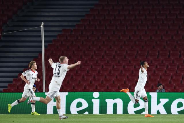 Frankfurt's German forward #07 Ansgar Knauff (R) celebrates scoring his team's first goal during the UEFA Champions League league phase day 6 football match between FC Barcelona and Eintracht Frankfurt at Camp Nou Stadium in Barcelona on December 9, 2025. (Photo by Josep LAGO / AFP)