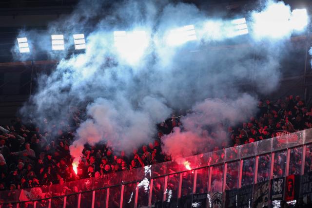 Frankfurt supporters light flares after Frankfurt scored their first goal during the UEFA Champions League league phase day 6 football match between FC Barcelona and Eintracht Frankfurt at Camp Nou Stadium in Barcelona on December 9, 2025. (Photo by Josep LAGO / AFP)
