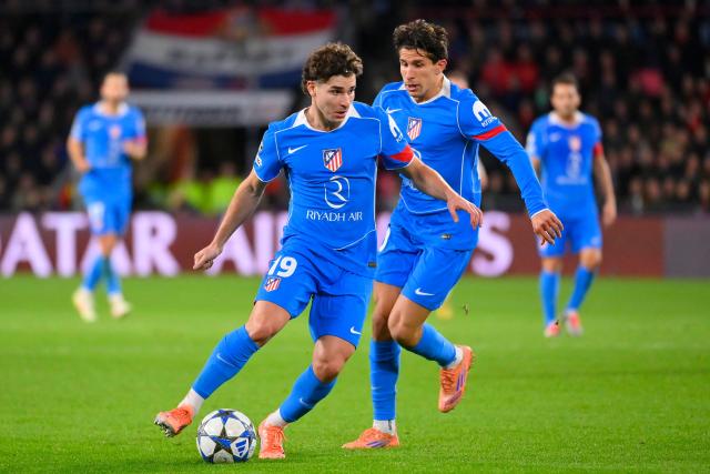 Atletico Madrid's Argentine forward #19 Julian Alvarez (centre L) runs with the ball during the UEFA Champions League, league phase day 6, football match between PSV Eindhoven (NED) and Atletico Madrid (ESP), at the Philips Stadion, in Eindhoven, south of The Netherlands, on December 9, 2025. (Photo by JOHN THYS / AFP)