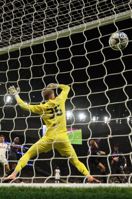 Slavia Prague's Czech defender #04 David Zima (centre right) heads the ball past Slavia Prague's Czech goalkeeper #36 Jindrich Stanek for an own-goal, Tottenham's first goal during the UEFA Champions League football league stage match between Tottenham Hotspur and Slavia Prague at the Tottenham Hotspur Stadium in London, on December 9, 2025. (Photo by Adrian DENNIS / AFP)