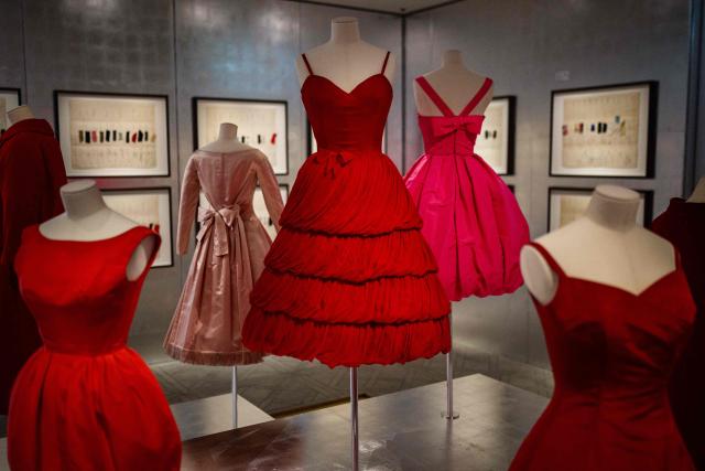This photograph shows dresses by Christian Dior displayed at the exhibition "Azzedine Alaia and Christian Dior, Two Masters of Haute Couture" from the Azzedine Alaia Foundation at La Galerie Dior in Paris, on December 9, 2025. The exhibition will run untill May 3, 2026. (Photo by Dimitar DILKOFF / AFP)