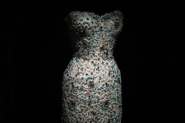 This photograph shows a dress by Christian Dior displayed at the exhibition "Azzedine Alaia and Christian Dior, Two Masters of Haute Couture" from the Azzedine Alaia Foundation at La Galerie Dior in Paris, on December 9, 2025. The exhibition will run untill May 3, 2026. (Photo by Dimitar DILKOFF / AFP)