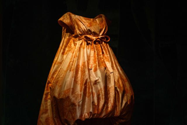 This photograph shows a dress by shows a dress by Yves Saint Laurent for Christian Dior displayed at the exhibition "Azzedine Alaia and Christian Dior, Two Masters of Haute Couture" from the Azzedine Alaia Foundation at La Galerie Dior in Paris, on December 9, 2025. The exhibition will run untill May 3, 2026. (Photo by Dimitar DILKOFF / AFP)