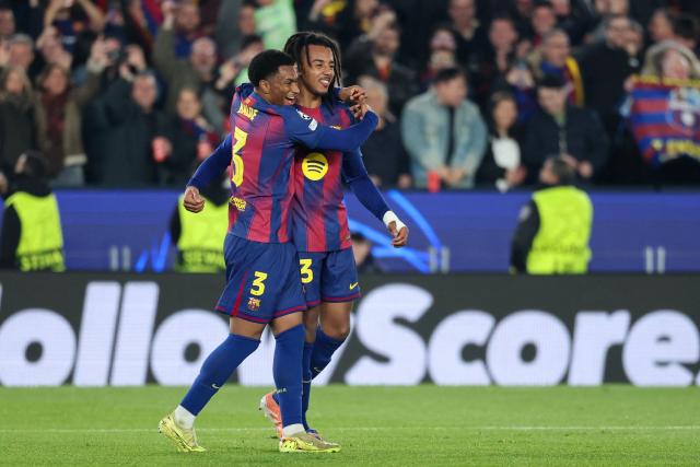 Barcelona's French defender #23 Jules Kounde (R) celebrates scoring his team's second goal with Barcelona's Spanish defender #03 Alex Balde during the UEFA Champions League league phase day 6 football match between FC Barcelona and Eintracht Frankfurt at Camp Nou Stadium in Barcelona on December 9, 2025. (Photo by Lluis GENE / AFP)