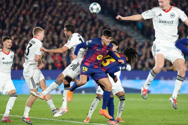 Barcelona's Spanish defender #18 Gerard Martin (C) and Frankfurt's Tunisian midfielder #15 Ellyes Skhiri go for a header during the UEFA Champions League league phase day 6 football match between FC Barcelona and Eintracht Frankfurt at Camp Nou Stadium in Barcelona on December 9, 2025. (Photo by Lluis GENE / AFP)