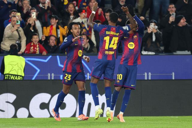 Barcelona's French defender #23 Jules Kounde (L) celebrates scoring his team's first goal during the UEFA Champions League league phase day 6 football match between FC Barcelona and Eintracht Frankfurt at Camp Nou Stadium in Barcelona on December 9, 2025. (Photo by Lluis GENE / AFP)