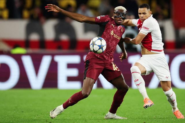 Galatasaray's Nigerian forward #45 Victor Osimhen (L) fights for the ball with Monaco's Brazilian defender #02 Vanderson  during the UEFA Champions League, league phase, football match between Monaco and Galatasaray, at the Stade Louis II stadium, in Monaco, on December 9, 2025. (Photo by Valery HACHE / AFP)