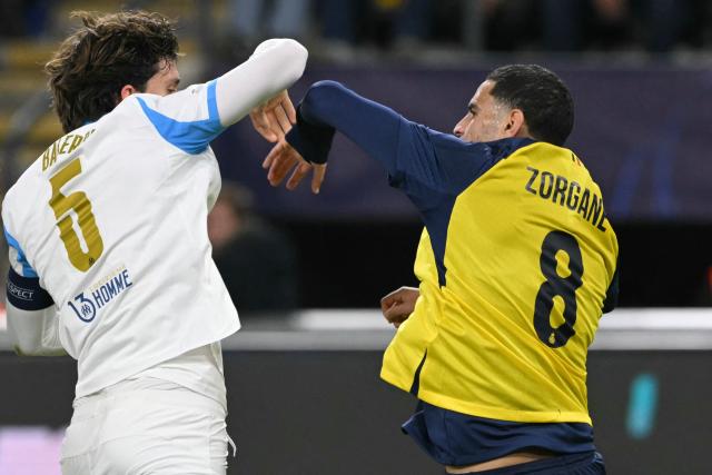 Union St-Gilloise's Algerian midfielder #08 Adem Zorgane (R) scuffles with Marseille's Argentine defender #05 Leonardo Balerdi (L) during the UEFA Champions League, league phase day 6, football match between Royale Union Saint-Gilloise (BEL) and Olympique de Marseille (FRA), at the RSC Anderlecht Stadium in Brussels, on December 9, 2025. (Photo by NICOLAS TUCAT / AFP)