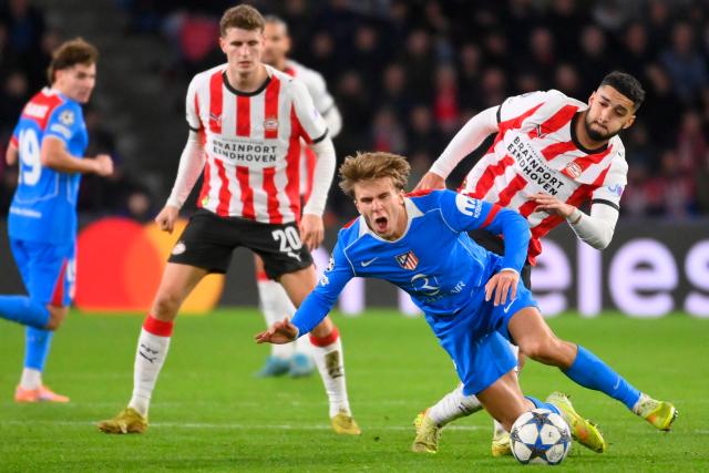 Atletico Madrid's Spanish midfielder #08 Pablo Barrios (bottom C) falls next to PSV Eindhoven's Moroccan midfielder #34 Ismael Saibari during the UEFA Champions League, league phase day 6, football match between PSV Eindhoven (NED) and Atletico Madrid (ESP), at the Philips Stadion, in Eindhoven, south of The Netherlands, on December 9, 2025. (Photo by JOHN THYS / AFP)