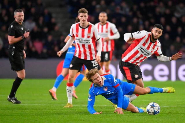 Atletico Madrid's Spanish midfielder #08 Pablo Barrios (bottom C) falls next to PSV Eindhoven's Moroccan midfielder #34 Ismael Saibari during the UEFA Champions League, league phase day 6, football match between PSV Eindhoven (NED) and Atletico Madrid (ESP), at the Philips Stadion, in Eindhoven, south of The Netherlands, on December 9, 2025. (Photo by JOHN THYS / AFP)