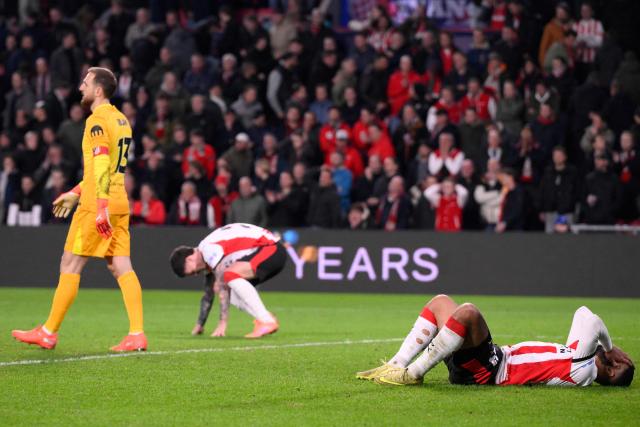 PSV players react at the end of the UEFA Champions League, league phase day 6, football match between PSV Eindhoven (NED) and Atletico Madrid (ESP), at the Philips Stadion, in Eindhoven, south of The Netherlands, on December 9, 2025. (Photo by JOHN THYS / AFP)