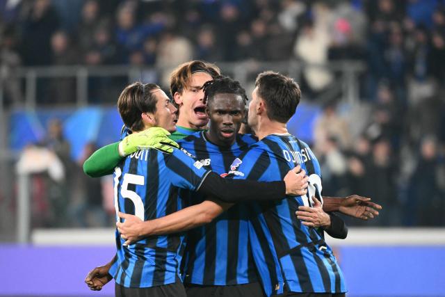 Atalanta's Ivorian defender #03 Odilon Kossounou celebrates with teammates after winning the UEFA Champions League league phase day 6 football match between Atalanta Bergamo and Chelsea FC at Bergamo Stadium, in Bergamo, on December 9, 2025. (Photo by Alberto PIZZOLI / AFP)