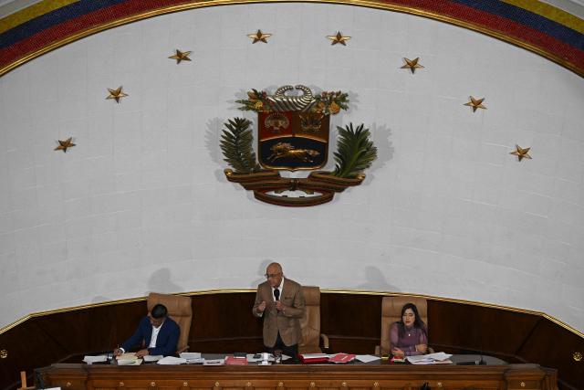 Venezuela's National Assembly President Jorge Rodriguez (C) speaks next to First Vice President Pedro Infante (L) and Second Vice President America Perez during a session at the National Assembly in Caracas on December 9, 2025. (Photo by Federico PARRA / AFP)