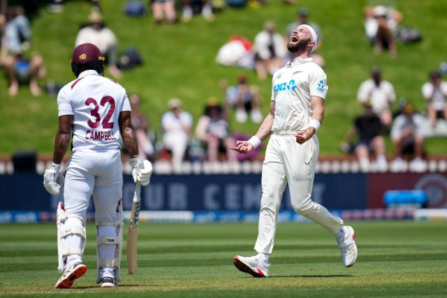 New Zealand Michael Rae (R) celebrates West Indies John Campbell being caught during day one of the 2nd international Test cricket match between New Zealand and West Indies at the Basin reserve in Wellington on December 10, 2025. (Photo by Marty MELVILLE / AFP)