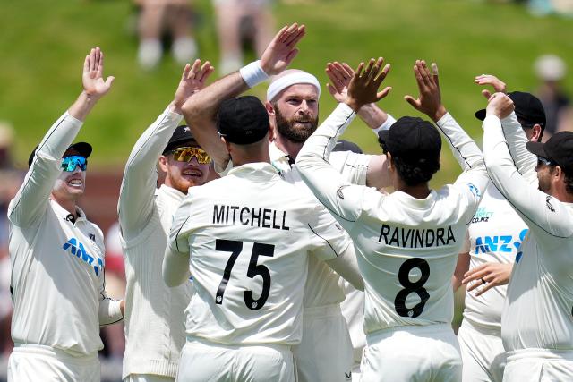 New Zealand Michael Rae (top C) celebrates West Indies John Campbell being caught with teammates during day one of the 2nd international Test cricket match between New Zealand and West Indies at the Basin reserve in Wellington on December 10, 2025. (Photo by Marty MELVILLE / AFP)