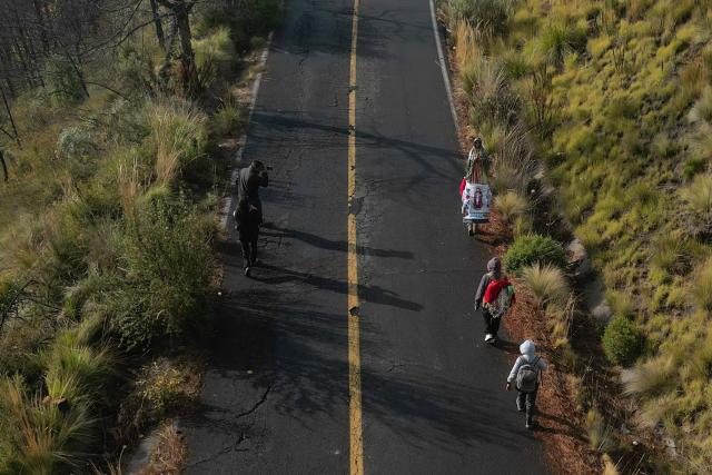 This aerial view shows people carrying images of the Virgin of Guadalupe during the pilgrimage to the Basilica of Guadalupe through Paso de Cortes, near Amecameca, Mexico on December 9, 2025. (Photo by Alfredo ESTRELLA / AFP)