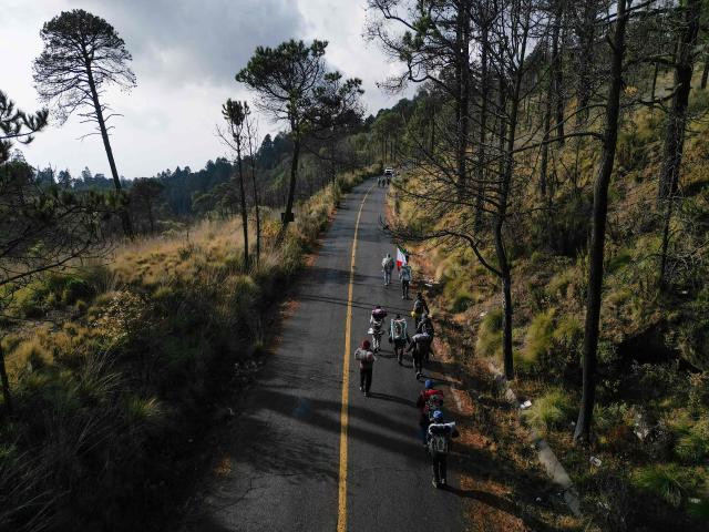 This aerial view shows people walking during the pilgrimage to the Basilica of Guadalupe through Paso de Cortes, near Amecameca, Mexico on December 9, 2025. (Photo by Alfredo ESTRELLA / AFP)