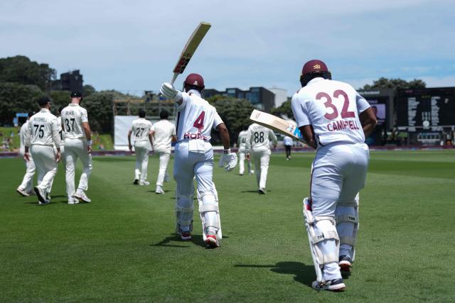 West Indies Shai Hope (C) and teammate John Campbell (R) walk onto the field after lunch during day one of the 2nd international Test cricket match between New Zealand and West Indies at the Basin reserve in Wellington on December 10, 2025. (Photo by Marty MELVILLE / AFP)