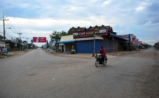 A man rides a motorcycle along a street in Oddar Meanchey province on July 30, 2025 following clashes along Cambodia-Thailand border. Fighting between Thailand and Cambodia spread to more parts of their contested border on Tuesday, forcing a mass exodus of civilians as the renewed hostilities derailed a US-brokered truce. (Photo by TANG CHHIN Sothy / AFP)