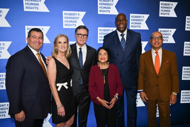 (L-R) Martin Cabrera Jr., Kerry Kennedy, Stephen Colbert, Dolores Huerta, Earvin "Magic" Johnson and Darren Walker attend the Robert F. Kennedy Human Rights 'Ripple of Hope Awards Gala' in New York City, on December 9, 2025. (Photo by ANGELA WEISS / AFP)