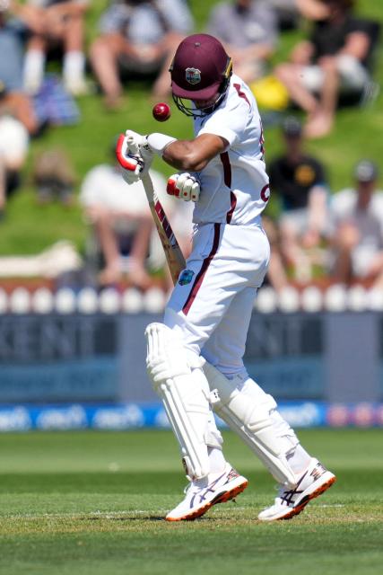 West Indies Roston Chase is hit by the ball during day one of the 2nd international Test cricket match between New Zealand and West Indies at the Basin reserve in Wellington on December 10, 2025. (Photo by Marty MELVILLE / AFP)