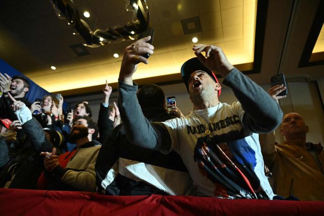 Attendees react after US President Donald Trump delivered remarks on the economy at Mount Airy Casino Resort in Mount Pocono, Pennsylvania, on December 9, 2025. (Photo by ANDREW CABALLERO-REYNOLDS / AFP)