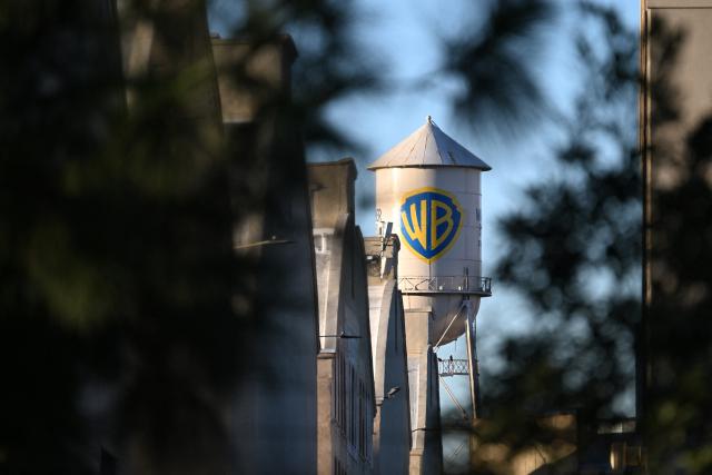 The WB water tower is seen at Warner Bros. Studios in Burbank, California, on December 9, 2025. Paramount on December 8 launched an all-cash tender offer to acquire Warner Bros. Discovery, the Hollywood giant that also owns CNN, in a challenge to Netflix's own highly contested deal. (Photo by Robyn Beck / AFP)