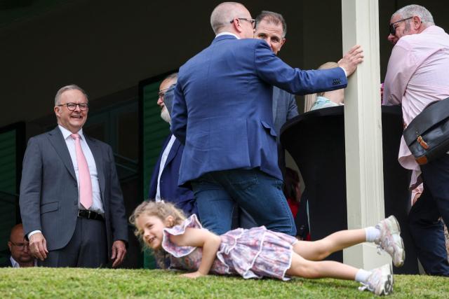 Australia’s Prime Minister Anthony Albanese (L) meets guests during an official function to mark the start of Australia’s social media reform at Kirrilbilli House in Sydney on December 10, 2025. Australia banned legions of young teenagers from social media with a world-first crackdown on December 10, declaring it was time to "take back control" from formidable tech giants. (Photo by DAVID GRAY / AFP)