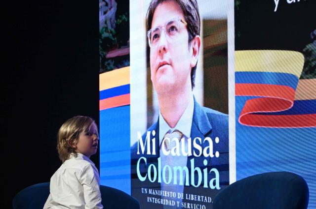 Alejandro Uribe, son of slain presidential hopeful and senator Miguel Uribe, gestures during the presentation of Uribe's autobiography "Mi Causa: Colombia" in Bogota on December 9, 2025. (Photo by Raul ARBOLEDA / AFP)