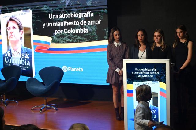 Maria Claudia Tarazona, widow of slain presidential hopeful and senator Miguel Uribe, and relatives speak during the presentation of Uribe's autobiography "Mi Causa: Colombia" in Bogota on December 9, 2025. (Photo by Raul ARBOLEDA / AFP)
