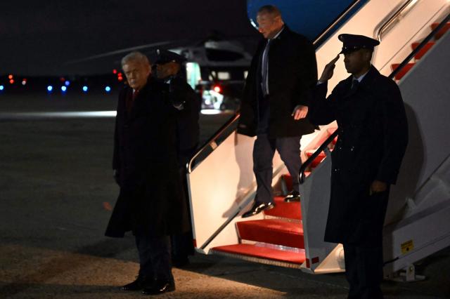 US President Donald Trump (L) steps off Air Force One at Joint Base Andrews, Maryland on December 9, 2025, after travelling to Pennsylvania, where he hold a political rally. (Photo by ANDREW CABALLERO-REYNOLDS / AFP)