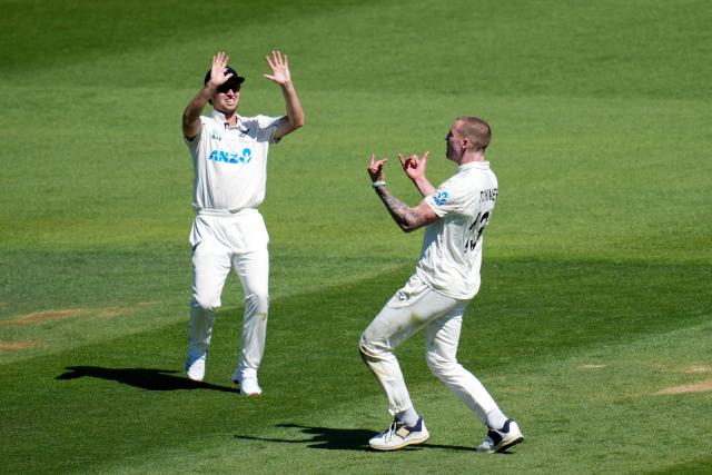 New Zealand's Blair Tickner (R) celebrates bowling West Indies' Roston Chase with teammate Zak Foulkes on day one of the 2nd international Test cricket match between New Zealand and West Indies at the Basin Reserve in Wellington on December 10, 2025. (Photo by Marty MELVILLE / AFP)