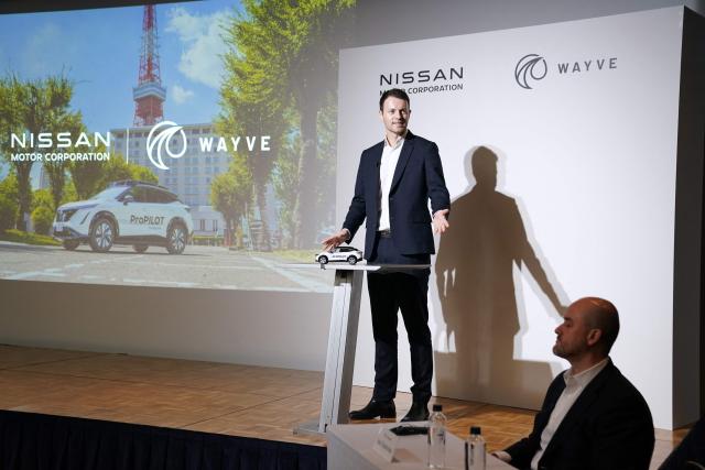 Wayve Technologies CEO Alex Kendall (L) delivers a speech while Nissan Motor CEO Ivan Espinosa (R) listens during a press conference before a signing ceremony for the collaboration agreement between the two companies regarding technologies for the ProPILOT next-generation driver assistance technology system in Tokyo on December 10, 2025. (Photo by Kazuhiro NOGI / AFP)