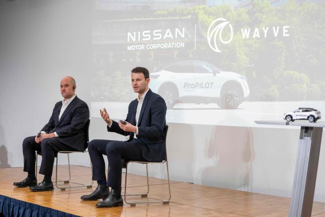 Wayve Technologies CEO Alex Kendall (R) answers questions while Nissan Motor CEO Ivan Espinosa (L) listens during a press conference before a signing ceremony for the collaboration agreement between the two companies regarding technologies for the ProPILOT next-generation driver assistance technology system in Tokyo on December 10, 2025. (Photo by Kazuhiro NOGI / AFP)