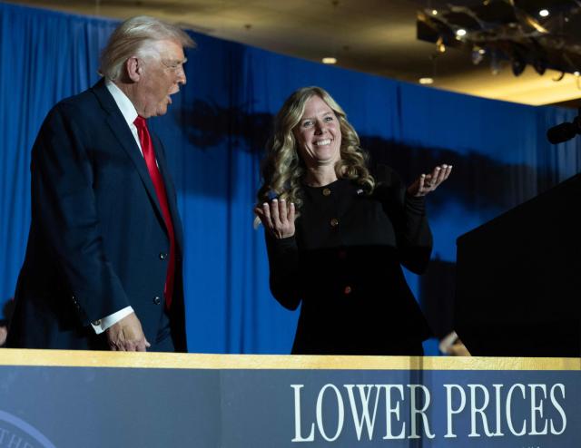 Megan Hemhauser (R), an attendee who was called by US President Donald Trump to join him on the stage, gestures after speaking as Trump delivered remarks on the economy at Mount Airy Casino Resort in Mount Pocono, Pennsylvania, on December 9, 2025. (Photo by ANDREW CABALLERO-REYNOLDS / AFP)