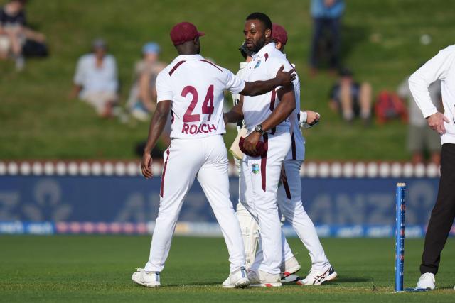 West Indies' Kemar Roach (L) and teammate Ojay Shields walk from the field at the end of the day's play during day one of the 2nd international Test cricket match between New Zealand and West Indies at the Basin reserve in Wellington on December 10, 2025. (Photo by Marty MELVILLE / AFP)