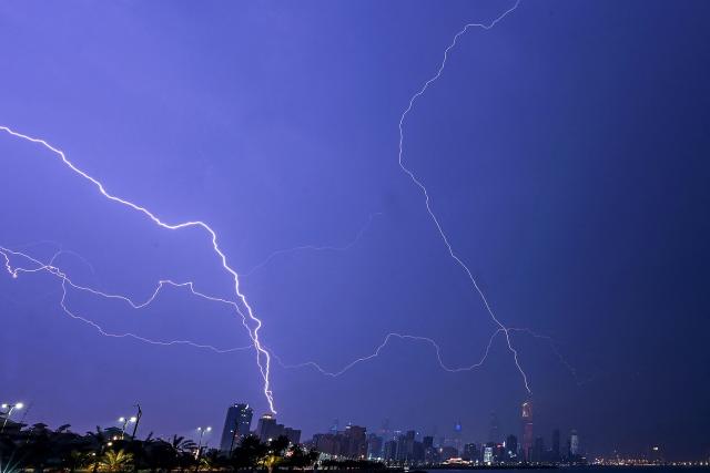 TOPSHOT - Lightning strikes over Kuwait City during a thunderstorm early on December 10, 2025. (Photo by Yasser Al-Zayyat / AFP)