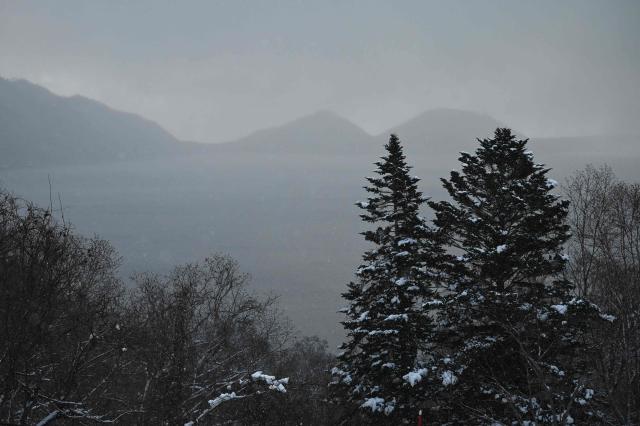 Snow covered trees are seen near Lake Shikotsu in the Shikotsu Toya National Park in Japan’s northern Hokkaido prefecture on December 10, 2025. (Photo by GREG BAKER / AFP)