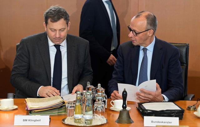 German Chancellor Friedrich Merz (R) and German Finance Minister and Vice Chancellor Lars Klingbeil sit at their places prior to the start of the weekly meeting of the German cabinet on December 10, 2025 at the Chancellery in Berlin. (Photo by John MACDOUGALL / AFP)