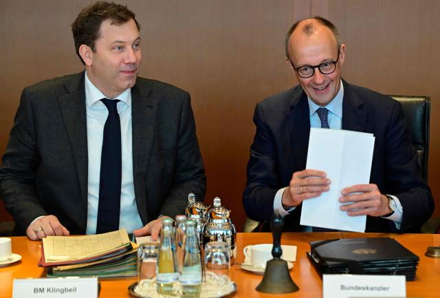 German Chancellor Friedrich Merz (R) and German Finance Minister and Vice Chancellor Lars Klingbeil sit at their places prior to the start of the weekly meeting of the German cabinet on December 10, 2025 at the Chancellery in Berlin. (Photo by John MACDOUGALL / AFP)