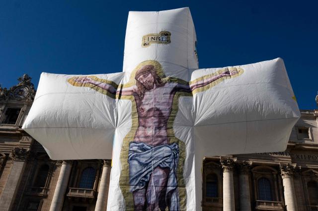 Pilgrims from the island of Ventotene carry an inflatable crucifix to St. Peter's Square at the end the weekly general audience in the Vatican on December 10, 2025. (Photo by TIZIANA FABI / AFP)