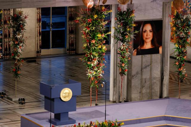 A portrait of Nobel Peace Prize 2025 laureate Venezuelan opposition leader Maria Corina Machado is on display prior to the ceremony on December 10, 2025 in Oslo, Norway. The director of the Nobel institute said on December 10, 2025 he was not aware where Venezuelan opposition leader Maria Corina Machado was after it was announced she would not attend the award of her Nobel Peace Prize.
The 2025 Nobel Peace Prize was awarded to Machado for her efforts to bring democracy to Venezuela, challenging the iron-fisted rule of Venezuelan President Nicolas Maduro, who has been president since 2013. (Photo by Odd ANDERSEN / AFP)