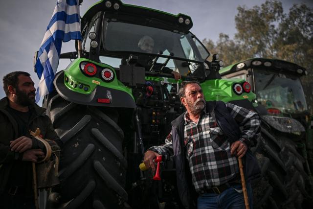 Farmers take part in the blocking of the passengers' port of the central Greek city of Volos during a demonstration on December 10, 2025. Thousands of Greek farmers have since late November 2025 blocked highways, mainly in the centre and north of the country, to demand swifter access to EU subsidies delayed by an ongoing probe into multi-million fraud. (Photo by Aris MESSINIS / AFP)