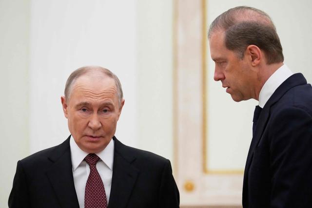 Russian President Vladimir Putin talks to First Deputy Prime Minister Denis Manturov prior to a meeting with Indonesian President at the Senate Palace of the Kremlin in Moscow on December 10, 2025. (Photo by Alexander Zemlianichenko / POOL / AFP)