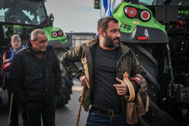 Farmers take part in the blocking of the passengers' port of the central Greek city of Volos during a demonstration on December 10, 2025. Thousands of Greek farmers have since late November 2025 blocked highways, mainly in the centre and north of the country, to demand swifter access to EU subsidies delayed by an ongoing probe into multi-million fraud. (Photo by Aris MESSINIS / AFP)