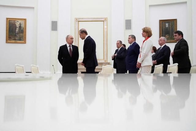 Russian President Vladimir Putin talks to First Deputy Prime Minister Denis Manturov prior to a meeting with Indonesian President at the Senate Palace of the Kremlin in Moscow on December 10, 2025. (Photo by Alexander Zemlianichenko / POOL / AFP)