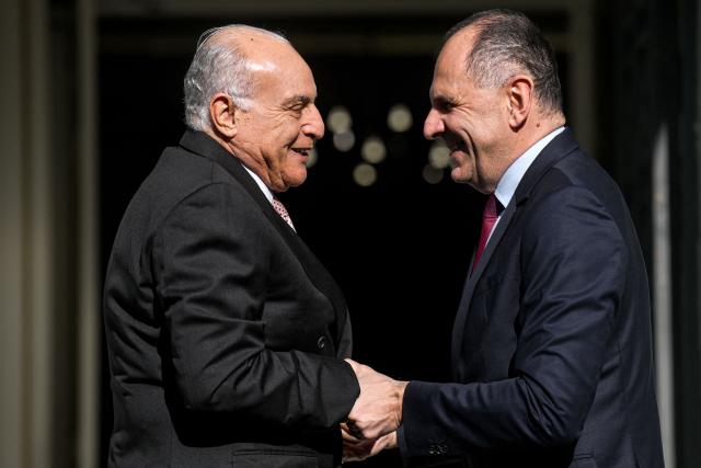 Greece's Foreign Minister Giorgos Gerapetritis (R) welcomes Algeria's Foreign Minister Ahmed Attaf prior to their meeting in Athens on December 10, 2025. (Photo by Angelos TZORTZINIS / AFP)