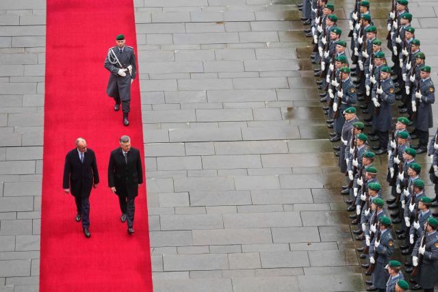 German Chancellor Friedrich Merz (L) and Croatia's Prime Minister Andrej Plenkovic walk along the red carpet during a welcoming ceremony in the courtyard of the Chancellery in Berlin on December 10, 2025. (Photo by Markus Schreiber / POOL / AFP)