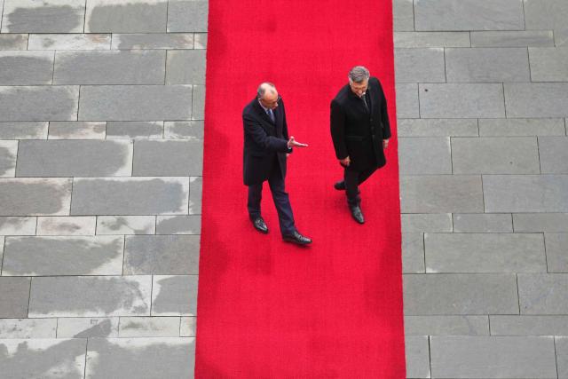 German Chancellor Friedrich Merz (L) and Croatia's Prime Minister Andrej Plenkovic walk along the red carpet during a welcoming ceremony in the courtyard of the Chancellery in Berlin on December 10, 2025. (Photo by Markus Schreiber / POOL / AFP)